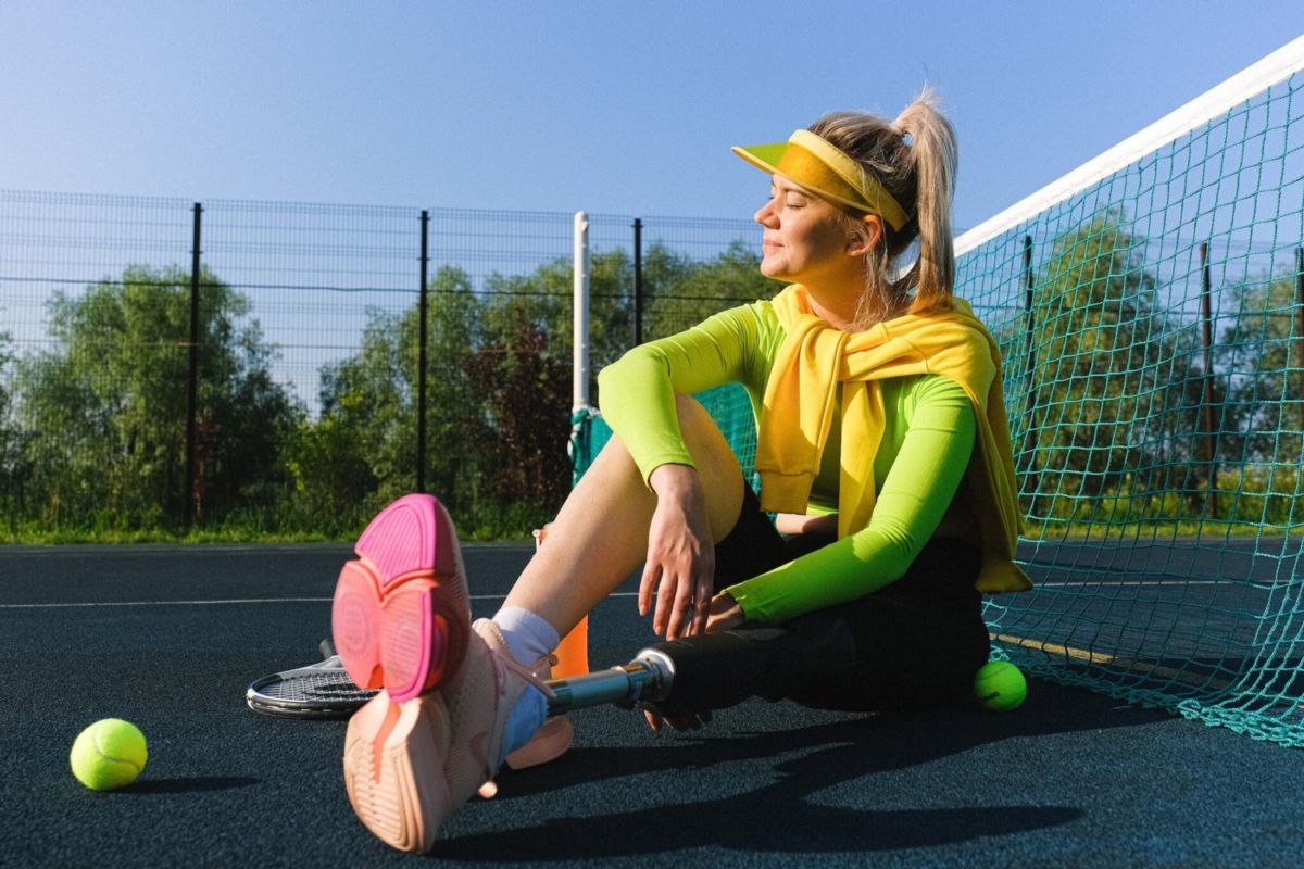 Woman relaxing on the tennis court at a private club